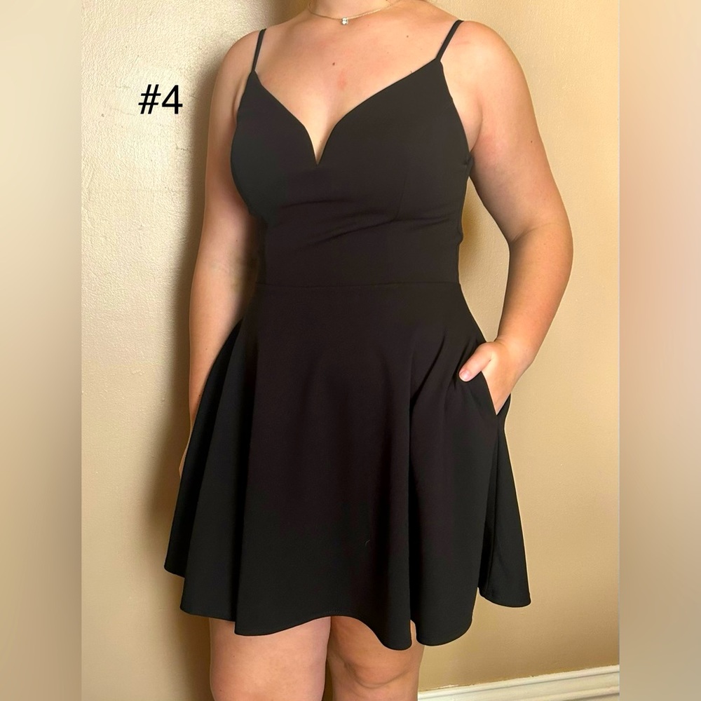 Short, black, V neck, spaghetti strap dress with pockets.